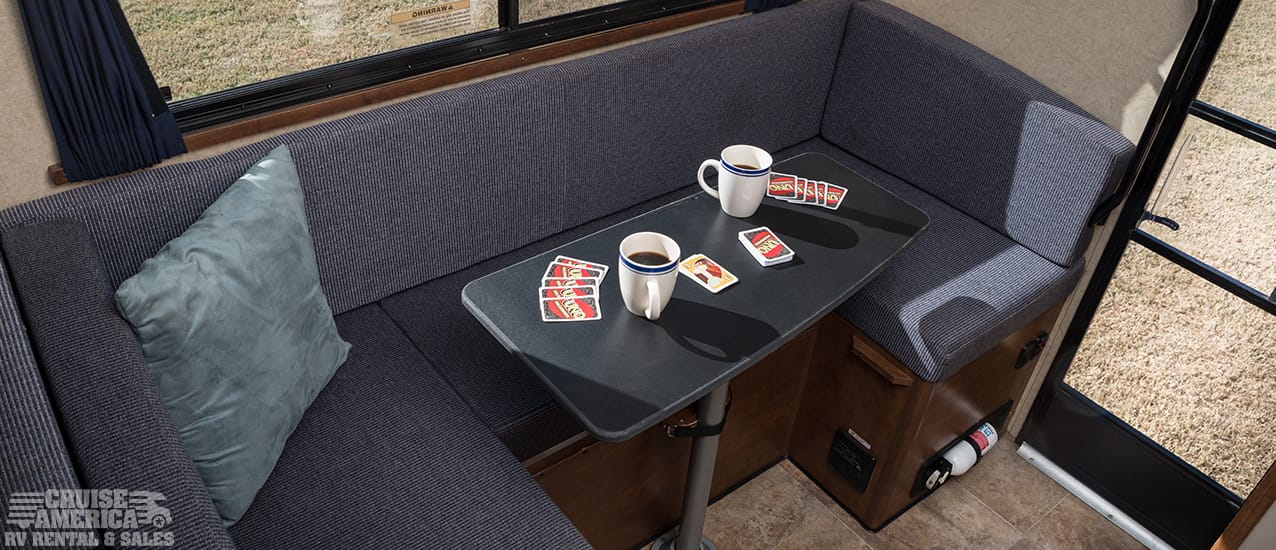 Dinette table that seats three, behind driver's seat.